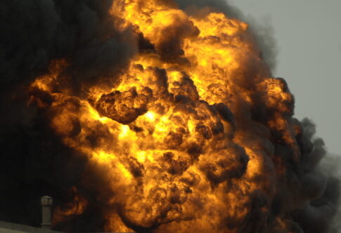 A large explosion with flames and thick smoke billowing into the sky
